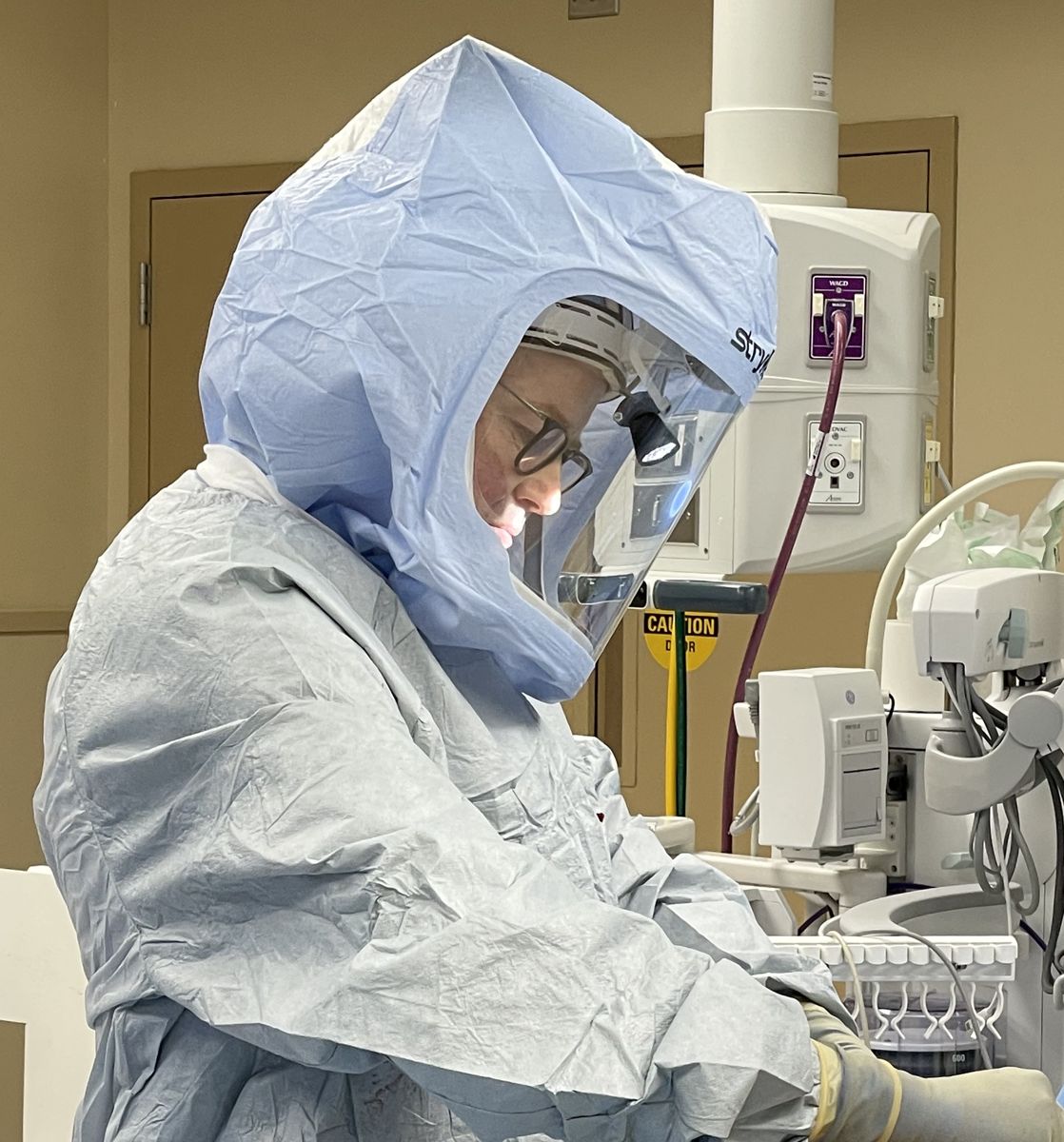 Dr. Olsen at work during a hip replacement, seen from the side
